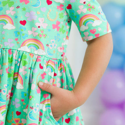 Model Wearing Rufflebutts + Ruggedbutts Girls Green Lucky Day Short Sleeve Knit Twirl Dress Pockets 