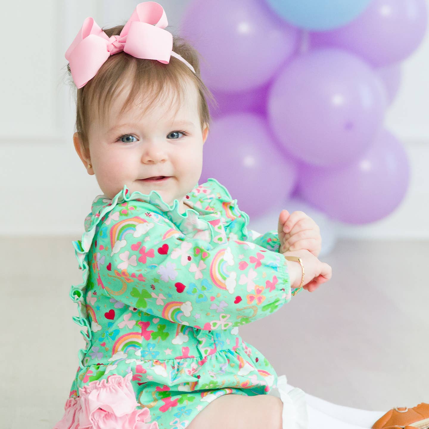 Model Wearing Rufflebutts + Ruggedbutts Baby Girls Green Lucky Day Knit Long Sleeve Waterfall Bubble Romper