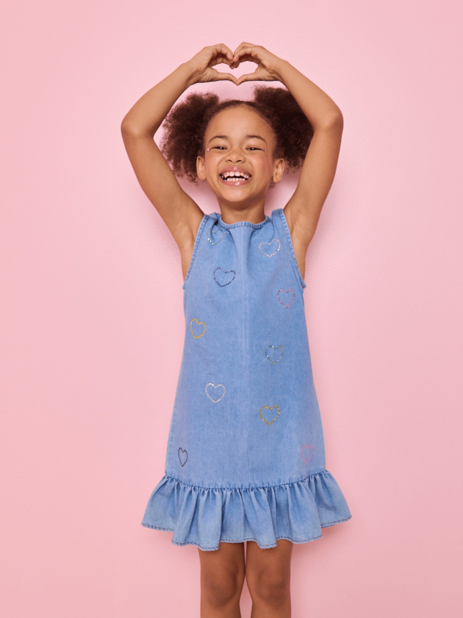 Model Wearing Lola And The Boys Crystal Rainbow Heart Denim Dress