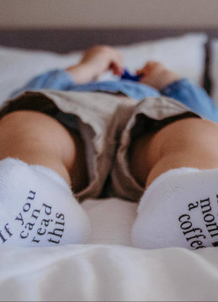 Model Wearing Dorothy's Reason If You Can Read This Bring My Mom A Coffee® Baby Socks Gifts