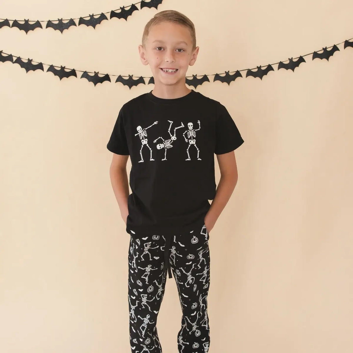 Model Wearing Sweet Wink Glow in the Dark Silly Skelly Halloween Short Sleeve T-Shirt