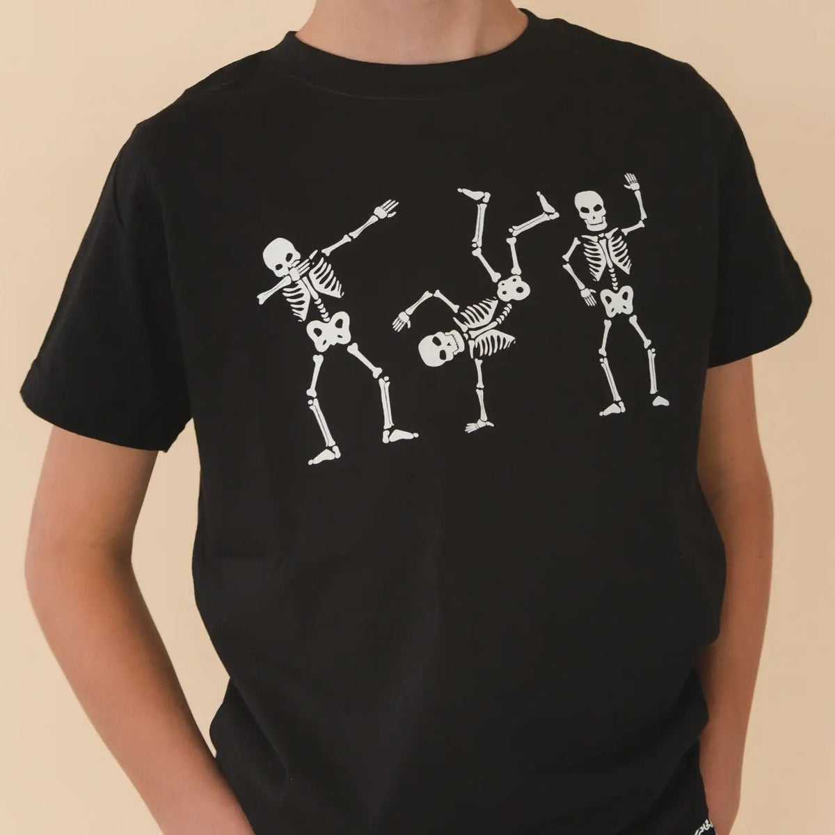 Model Wearing Sweet Wink Glow in the Dark Silly Skelly Halloween Short Sleeve T-Shirt