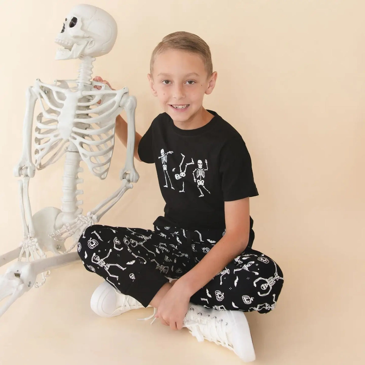 Model Wearing Sweet Wink Glow in the Dark Silly Skelly Halloween Short Sleeve T-Shirt