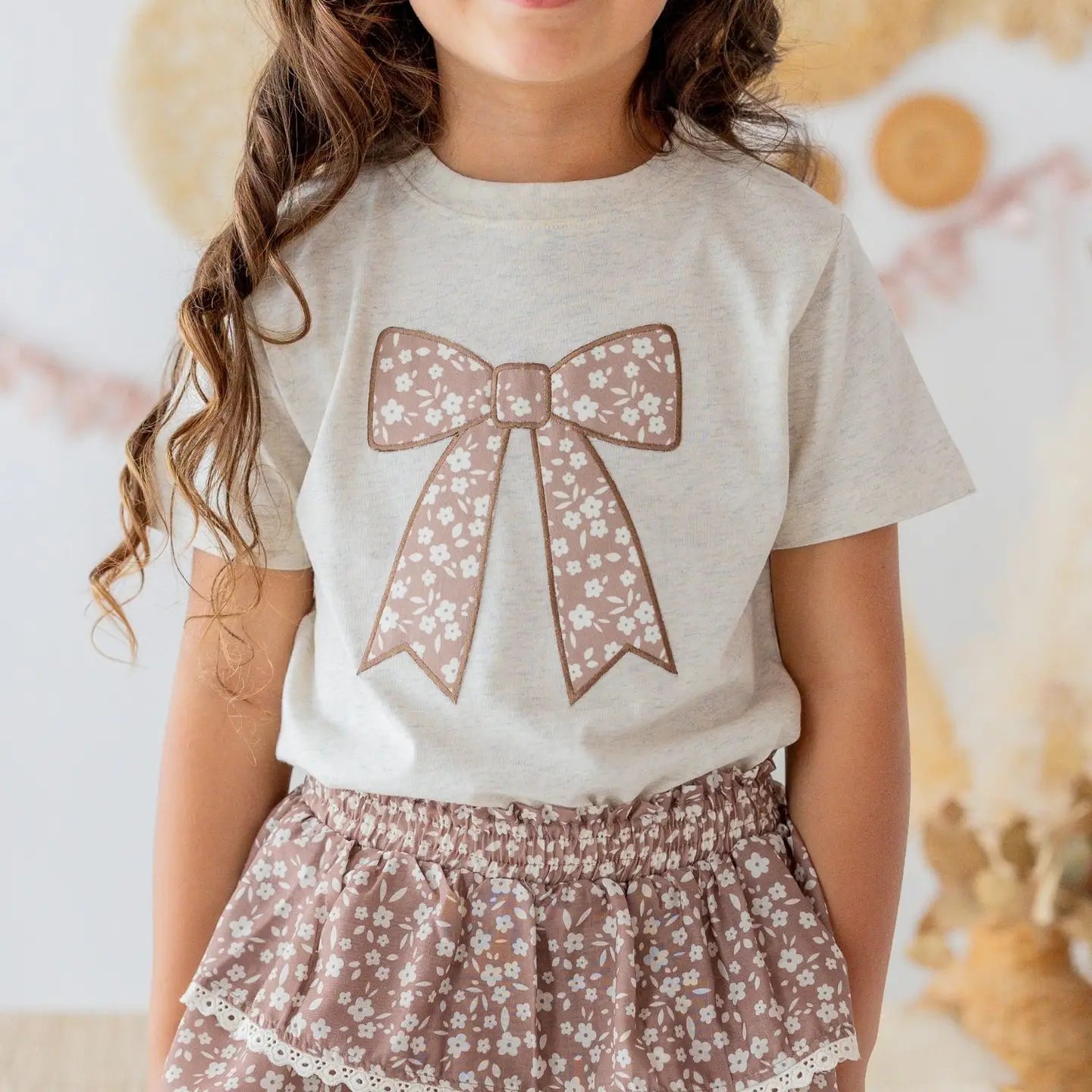 Model Wearing Sweet Wink Mocha Floral Bow Patch Short Sleeve T-Shirt - Kids Clothing
