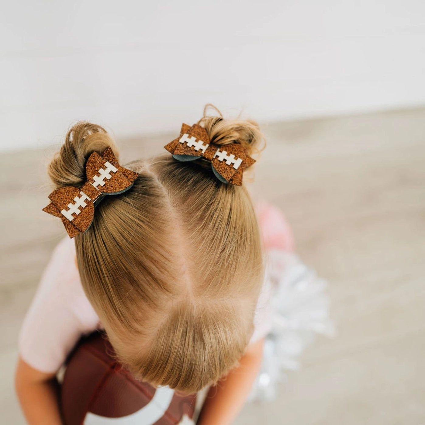 Model Wearing Sweet Wink Game Day Glitter Bow Clip Set - Football - Kids Hair