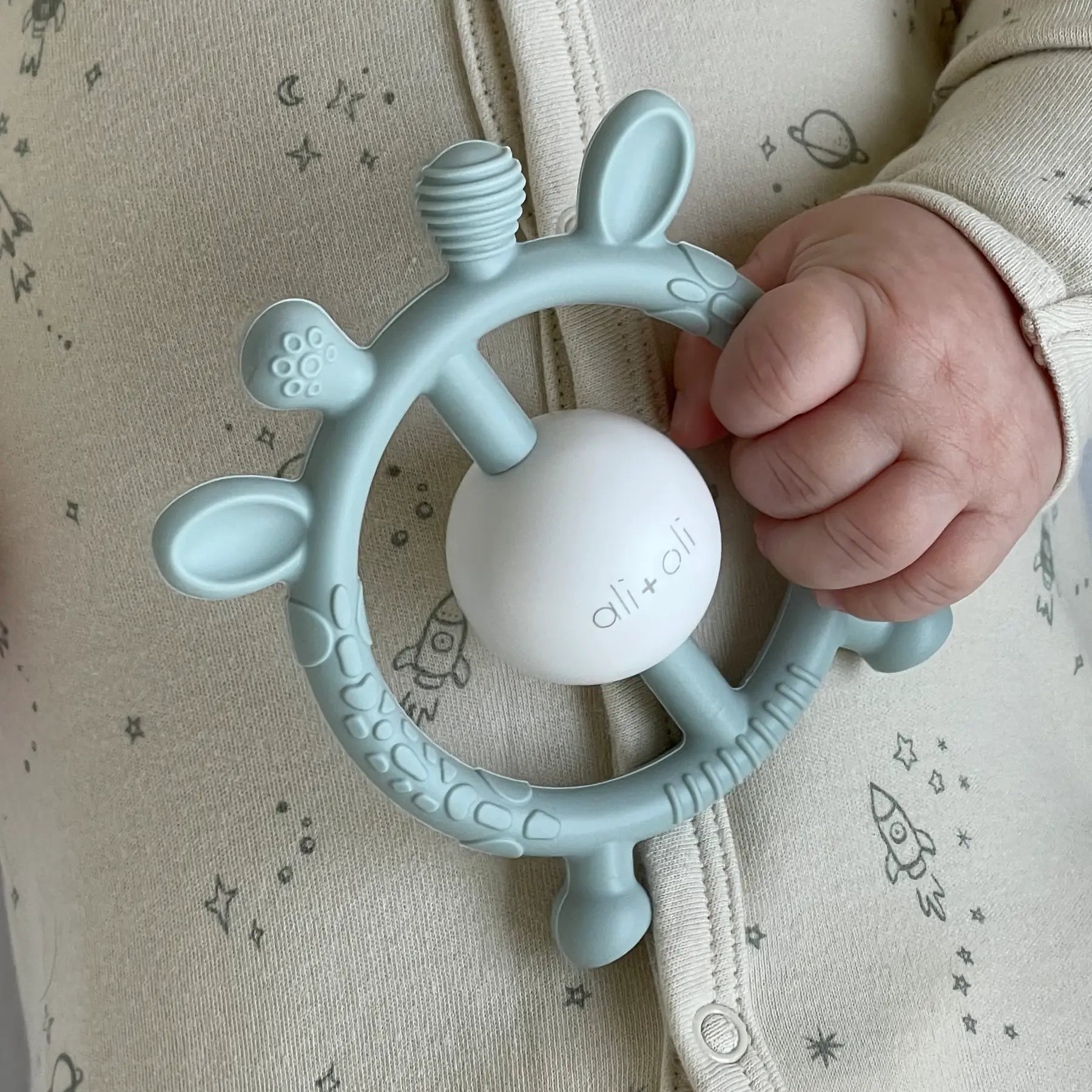 Model Using Ali + Oli Giraffe Teether & Rattle Food-Grade Silicone Toy (Mist)