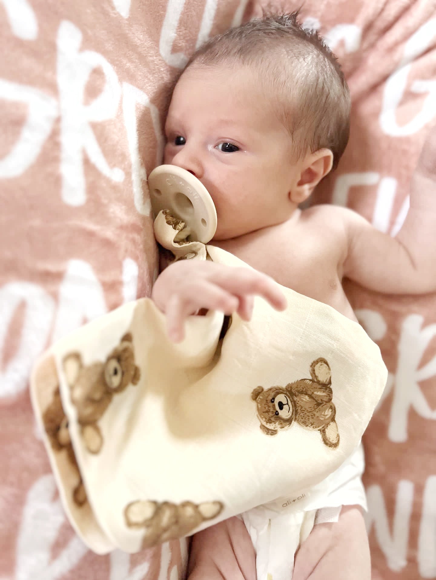 Model Using Ali + Oli Pacifier Blanket Holder Bamboo Muslin (Teddy Bear)