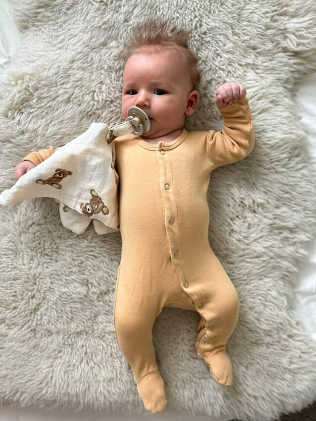Model Using Ali + Oli Pacifier Blanket Holder Bamboo Muslin (Teddy Bear)