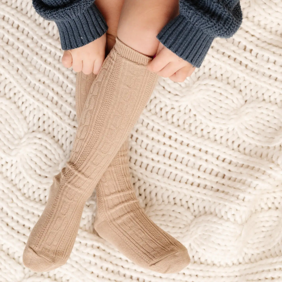 Model Wearing Little Stocking Co. Oat Cable Knit Knee High Socks