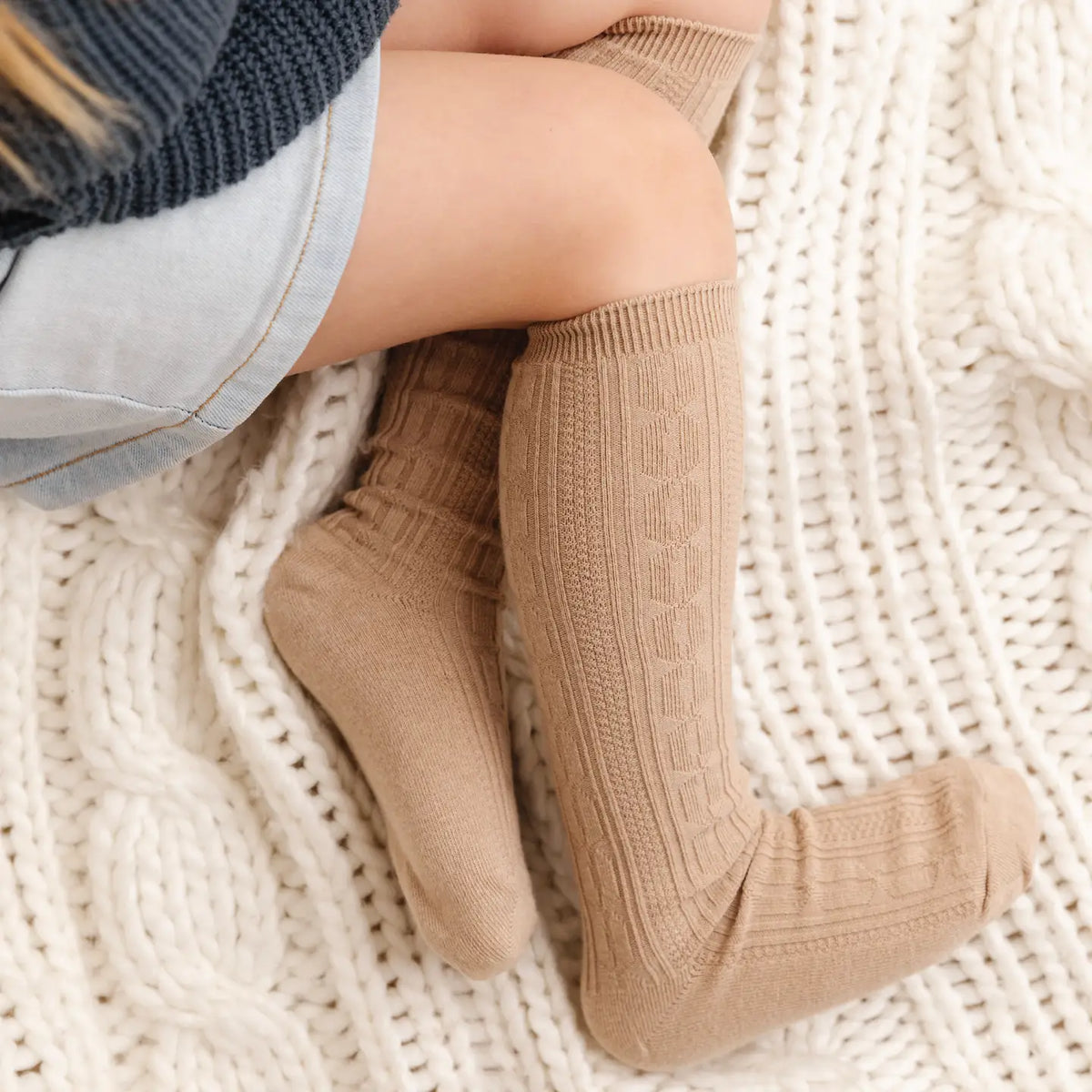 Model Wearing Little Stocking Co. Oat Cable Knit Knee High Socks