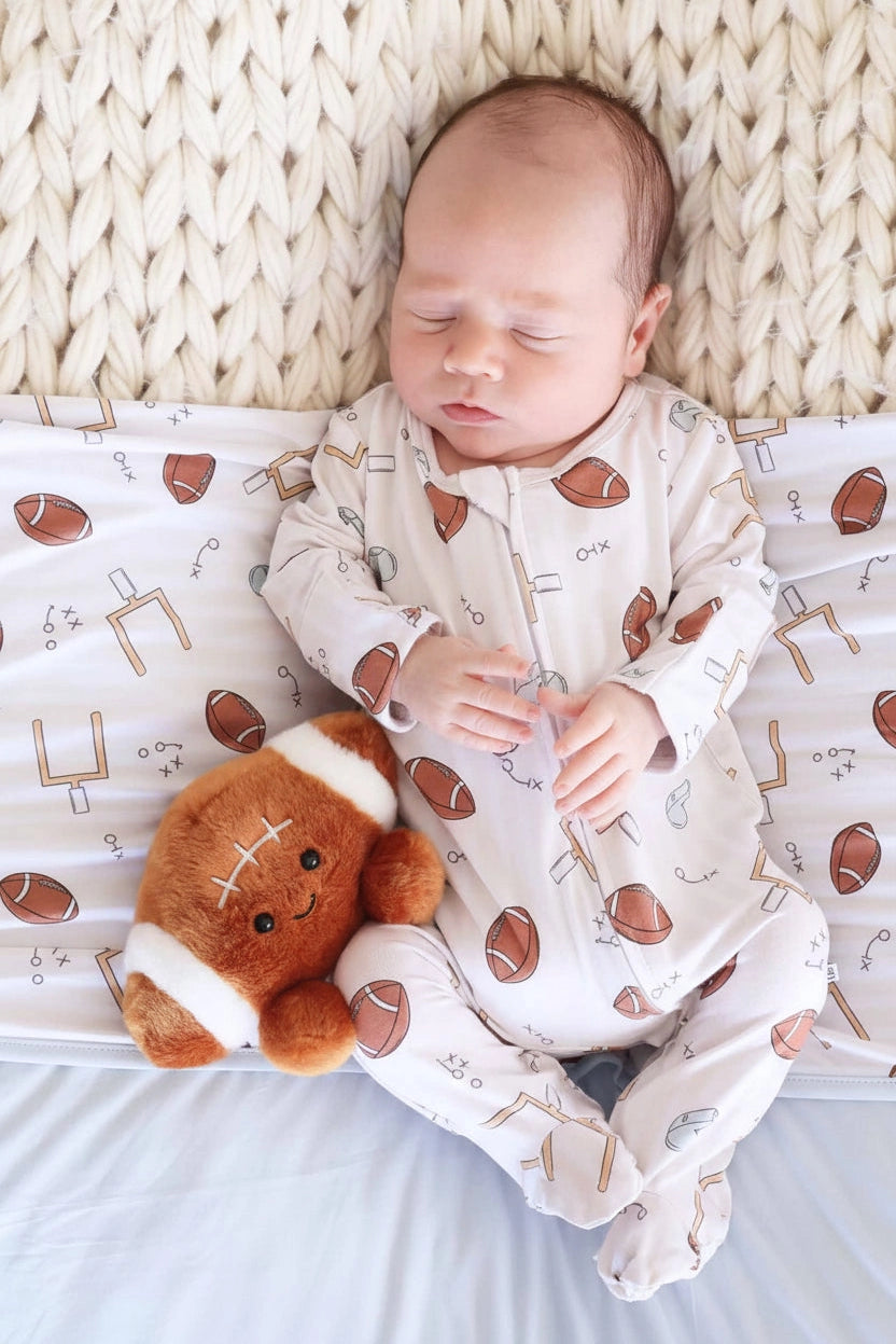 Model Wearing Caden Lane 
Tiny Touchdowns Zipper Footie | Neutral