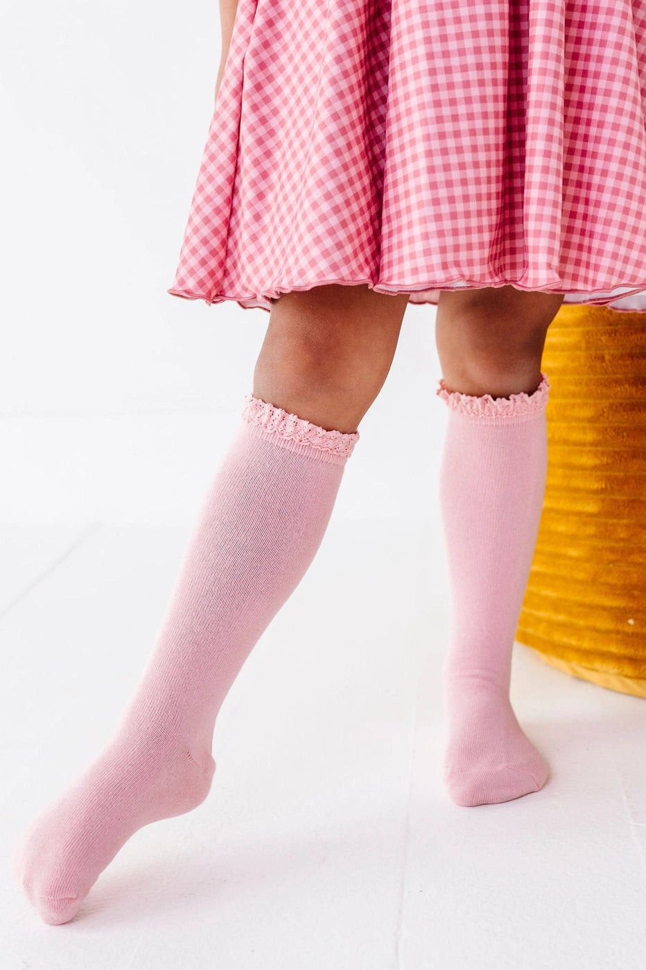 Model Wearing Little Stocking Co. Quartz Pink Lace Top Knee High Socks