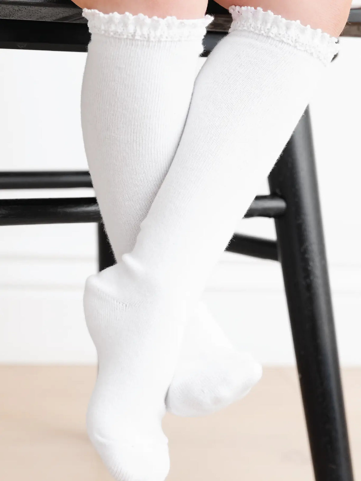 Model Wearing Little Stocking Co. White Lace Top Knee High Socks