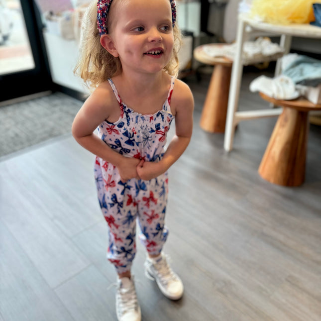Model Wearing Snugglebums Red, White, and Bows Jumpsuit
