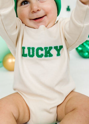 Model wearing Lucky Varsity Patch St. Patrick's Day Long Sleeve Romper - Natural