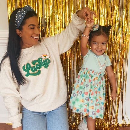 Models wearing Sweet Wink Lucky Rainbow Patch St. Patrick's Day Adult Sweatshirt - Natural