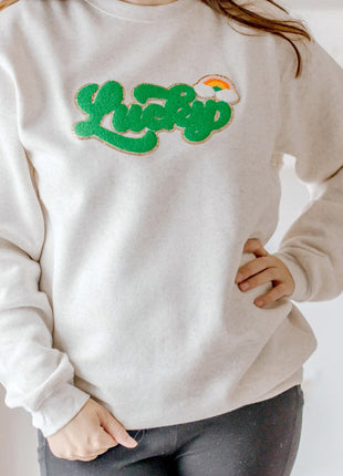 Model wearing Sweet Wink Lucky Rainbow Patch St. Patrick's Day Adult Sweatshirt - Natural