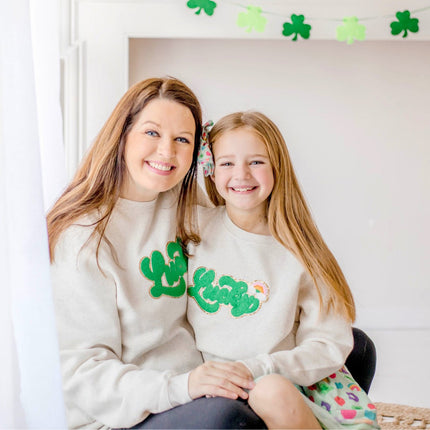 Models wearing Sweet Wink Lucky Rainbow Patch St. Patrick's Day Adult Sweatshirt - Natural