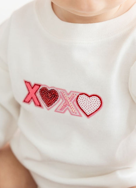 Model Wearing Sweet Wink XOXO sequin Patch Valentine's Day Long Sleeve Romper 