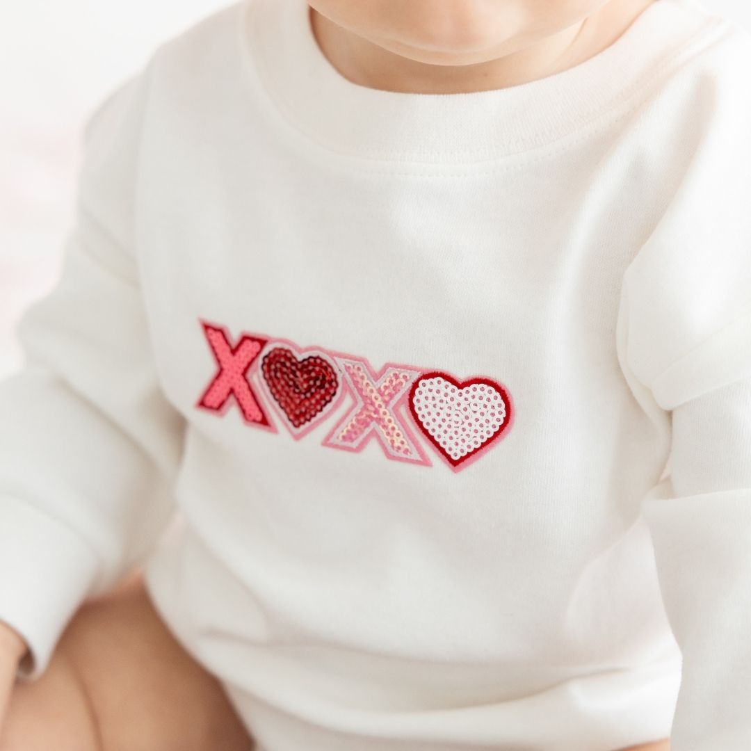 Model Wearing Sweet Wink XOXO sequin Patch Valentine's Day Long Sleeve Romper 