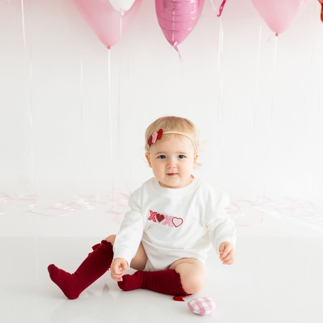 Model Wearing Sweet Wink XOXO sequin Patch Valentine's Day Long Sleeve Romper 