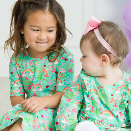 Model Wearing Rufflebutts + Ruggedbutts Girls Green Lucky Day Short Sleeve Knit Twirl Dress Front Coordinating romper & dress