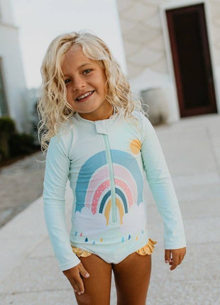 Model Wearing Oopsie Daisy Kids Mint Rainbow Zip Rash Guard One Piece Swimsuit