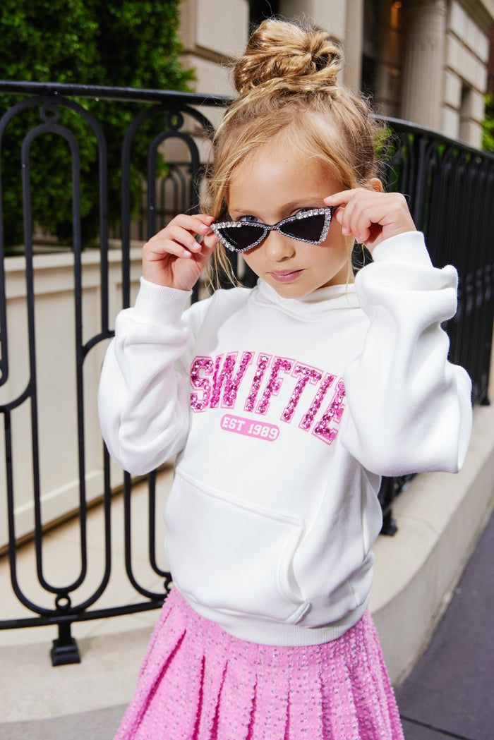 Model Wearing Lola And The Boys Pink Denim Sparkle Pleated Skirt & Swiftie Sweatshirt