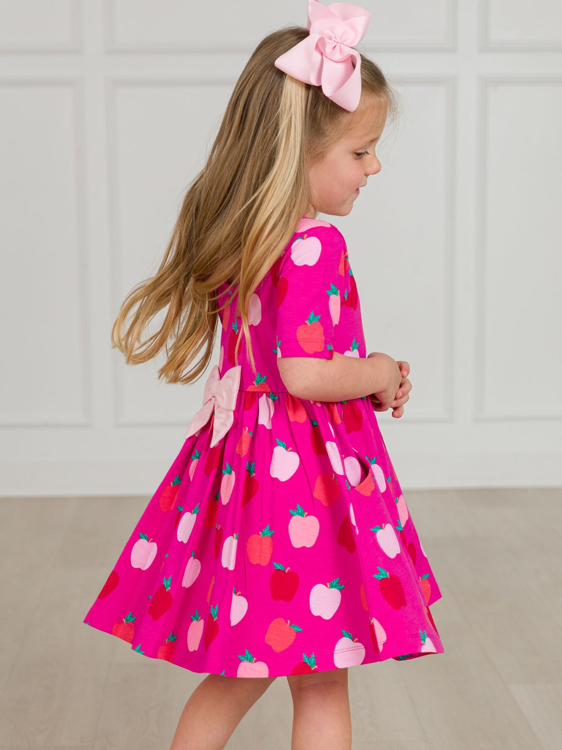 Model Wearing Rufflebutts+ Ruggedbutts Girls Apple of My Eye Short Sleeve Knit Twirl Dress
