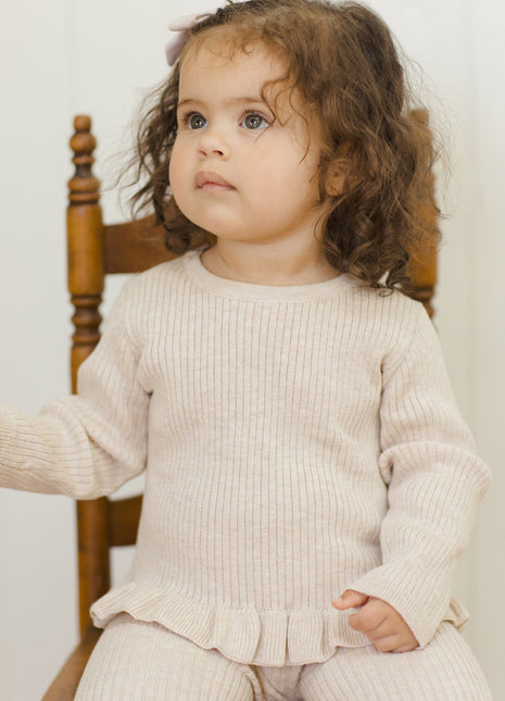 Model Wearing Quincy Mae Rib Knit Peplum Top || Heathered Oatmeal
