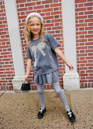 Model Wearing Lola & The Boys Sparkle Bow Charm Skirt Set