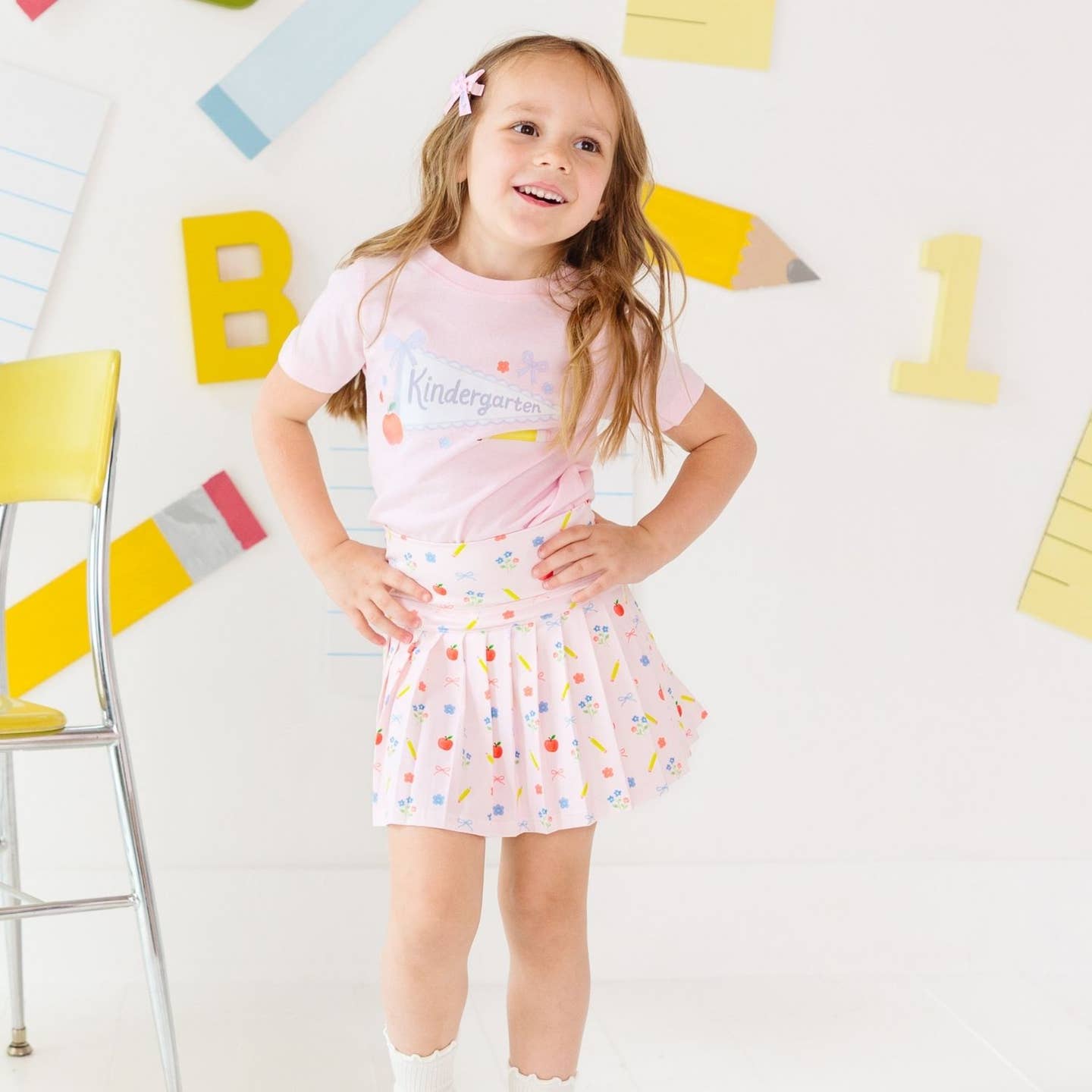 Model Wearing Sweet Wink Alphabet Bows Clip Set - Back To School - Hair Clips and Sweet Wink Kindergarten Pennant Short Sleeve T-Shirt - Back To School