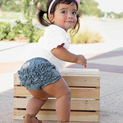 Model Wearing Rufflebutts+ Ruggedbutts Baby Girls Light Wash Denim Rufflebutt Bloomer