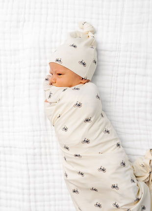 Model Wearing Lou Lou & Company Freddy Swaddle Blanket and knotted hat