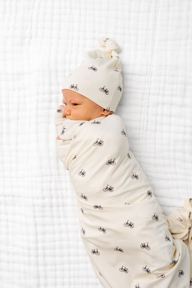 Model Wearing Lou Lou & Company Freddy Swaddle Blanket and knotted hat