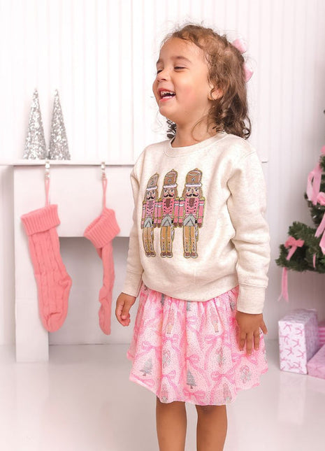 Model Wearing Sweet Winks Pastel Nutcracker Patch Christmas Sweatshirt - Natural