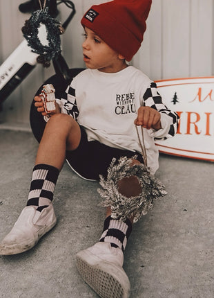 Model Wearing Ak Clothing Co. Rebel Without A Claus-Crewneck Kids