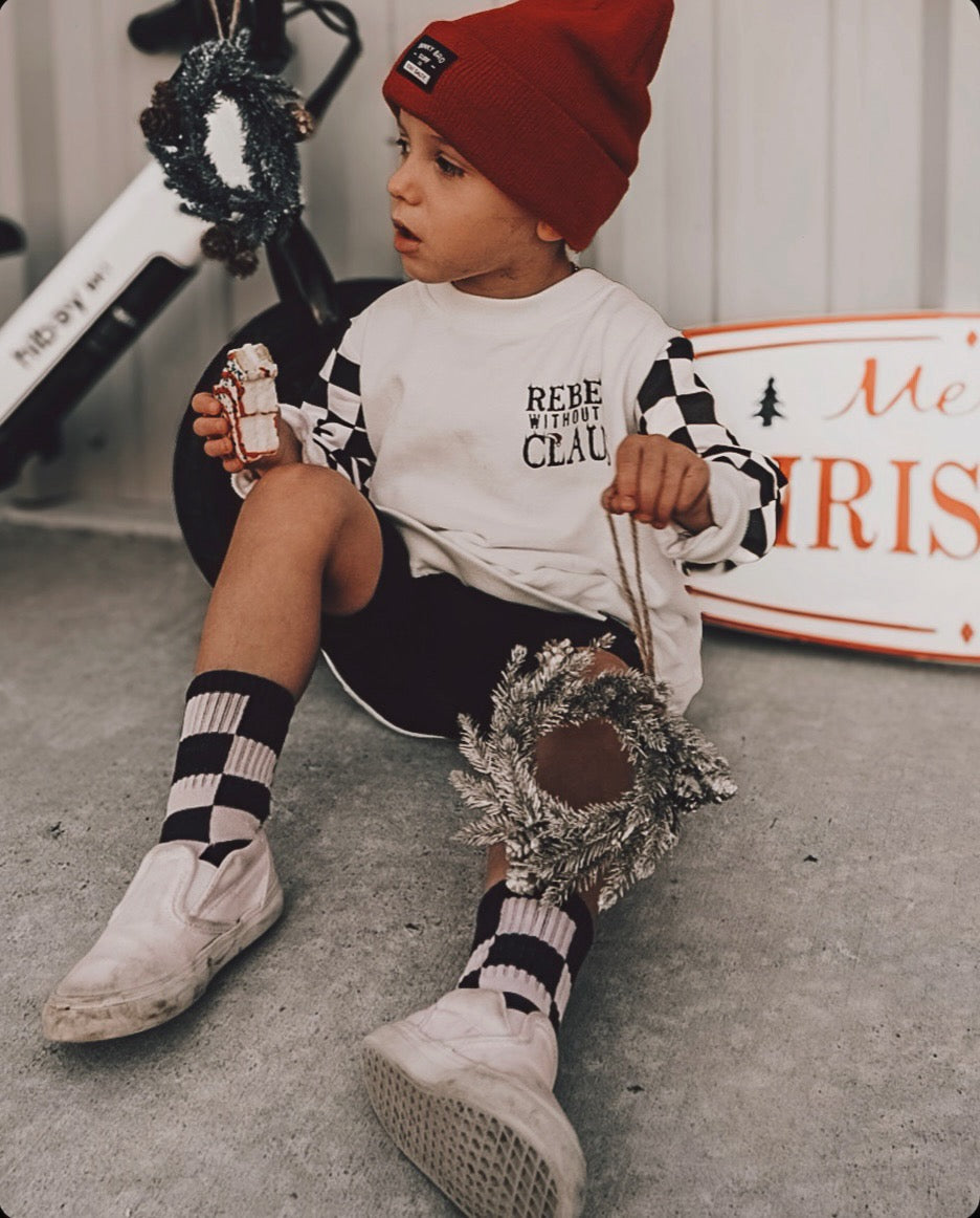Model Wearing Ak Clothing Co. Rebel Without A Claus-Crewneck Kids