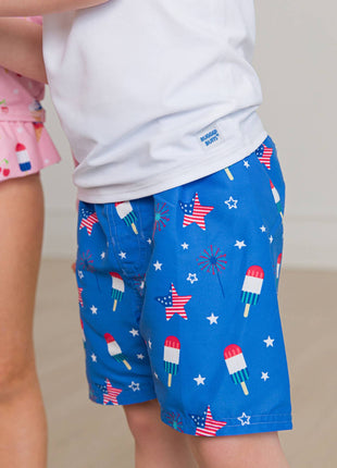 Model Wearing Rufflebutts + Ruggedbutts Boys Freedom Fireworks Swim Trunks