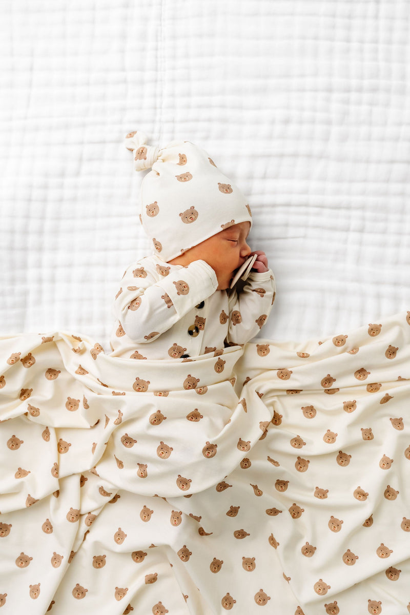 Model Wearing Lou Lou & Company Teddy Knotted Gown, knot hat, and swaddle blanket