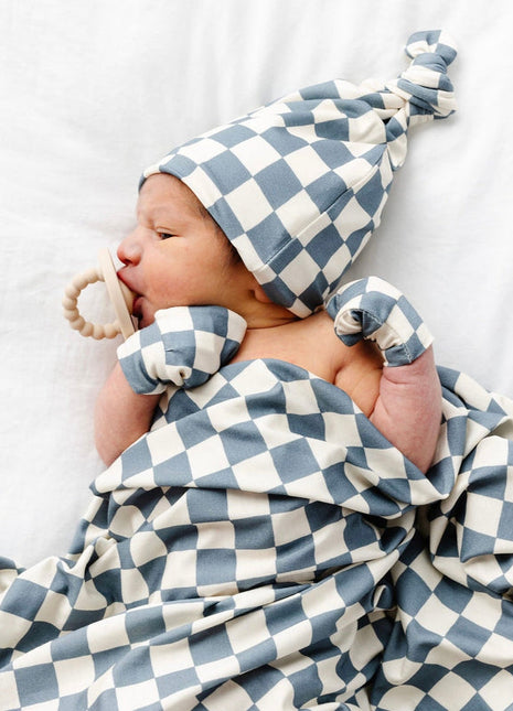 Model Wearing Lou Lou & Company Miles Swaddle Blanket, Mittens, and knot hat
