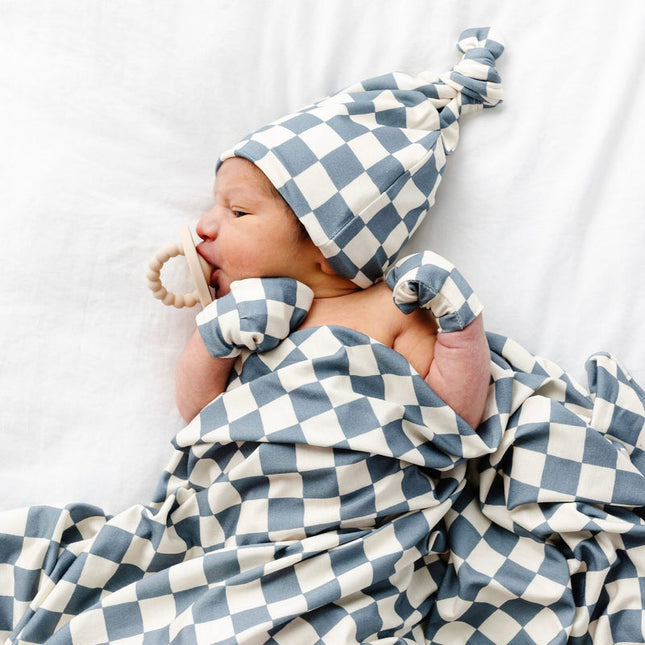 Model Wearing Lou Lou & Company Miles Swaddle Blanket, Mittens, and knot hat