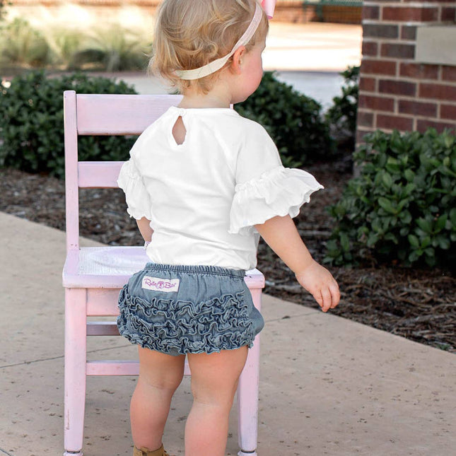 Model Wearing Rufflebutts+ Ruggedbutts Baby Girls Light Wash Denim Rufflebutt Bloomer