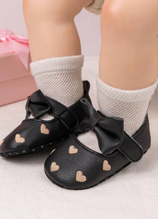 Model Wearing Kids Charm Online Black W/Gold Heart Infant Shoes with Velcro. HMZ1615