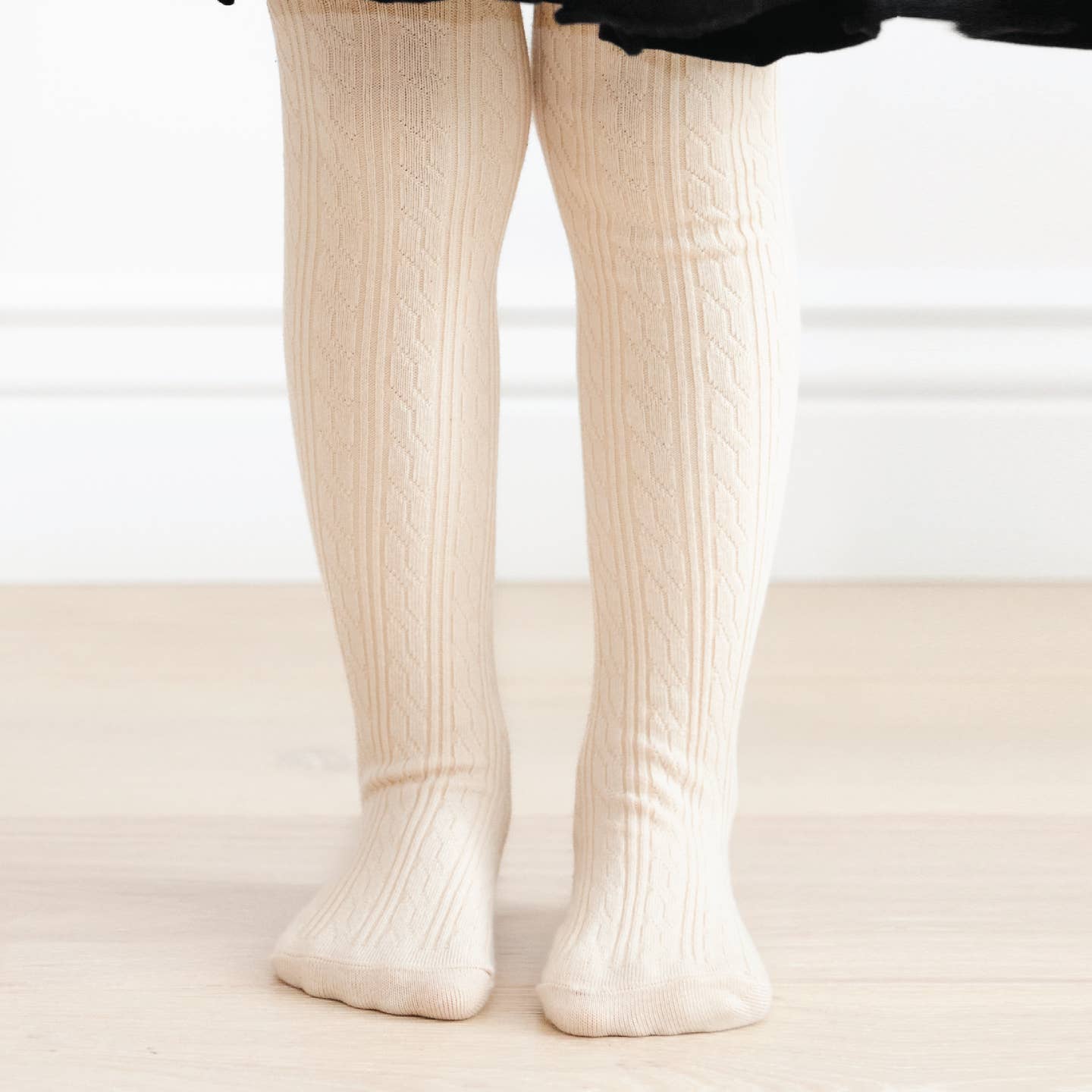 Model Wearing Little Stocking Co. Vanilla Cable Knit Tights