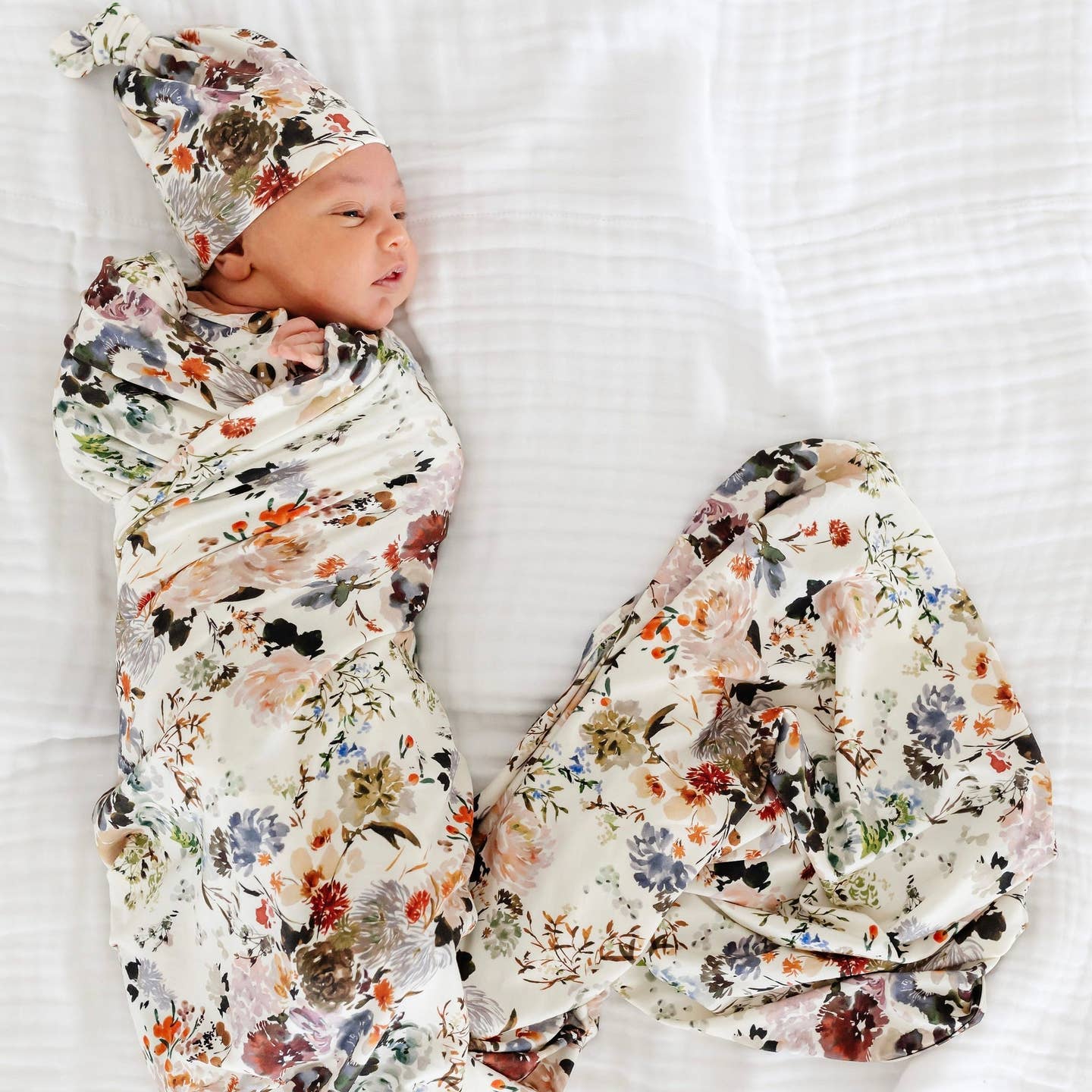 Model Wearing Lou Lou & Company Nellie Top Knot Hat & Swaddle Blanket