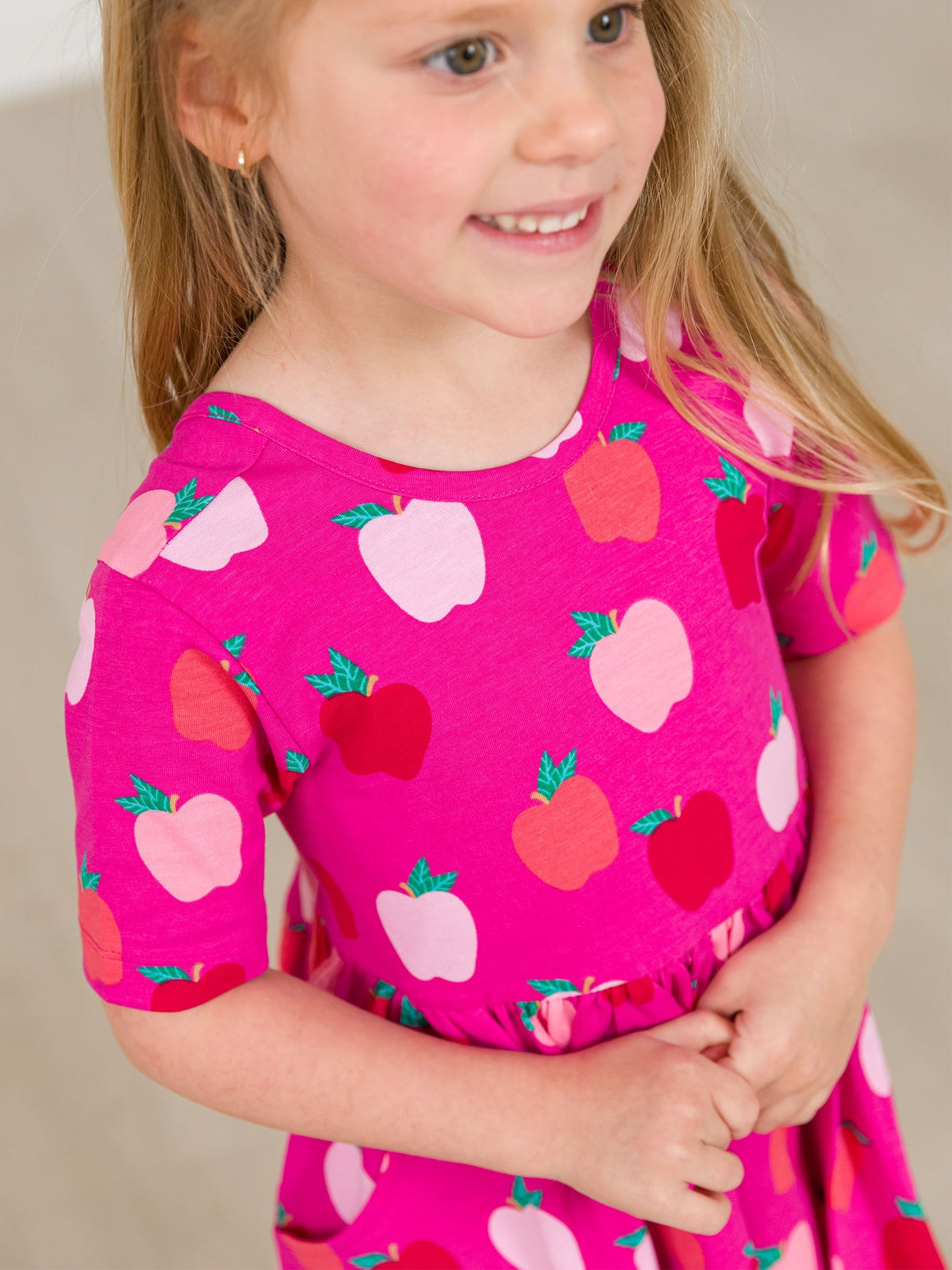 Model Wearing Rufflebutts+ Ruggedbutts Girls Apple of My Eye Short Sleeve Knit Twirl Dress