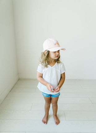 Model Wearing Cash & Co Blushing Rainbow Hat