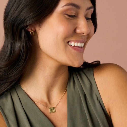 Model Wearing Demdaco Daisy Charm Gold Necklace 16in