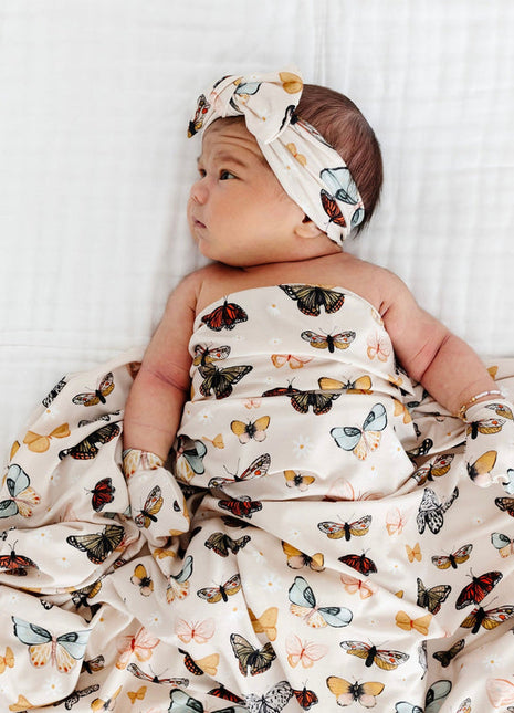 Model Wearing Lou Lou & Company Amelia Swaddle Blanket, headband, and Mittens